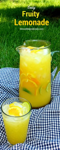 a pitcher of lemonade sitting on top of a blue and white checkered table cloth