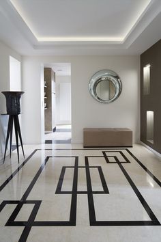 a living room filled with furniture and a round mirror