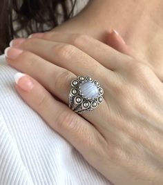 This is a beautiful filigree art designer handcrafted ring made with 925 sterling silver and a natural blue lace agate gemstone. The blue stone is a 10x12 mm cabochon oval cut. The ring face length is 0.9 inches / 22.50 mm and width is 0.80 inches / 20.00 mm. The ring is oxidized and highly polished and the ring face length is 0.9 inches / 22.50 mm and width is 0.80 inches / 20.00 mm. It comes with a velvet pouch, silver polish cloth and a luxurious gift box, making it the perfect option for any Elegant Moonstone Ring Ideal For Gifting, Handmade Agate Moonstone Ring Gift, Handmade Silver Chalcedony Moonstone Ring, Elegant Blue Moonstone Ring Stamped 925, The Ring Face, Silver Polish, Dome Ring, Silver Jewels, Box Making