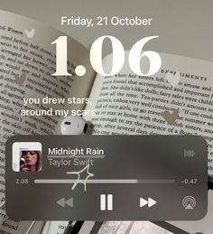 an open book with the words midnight rain on it, next to a pair of headphones