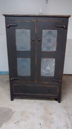 an old wooden cabinet with glass doors on the front and side panels in different colors