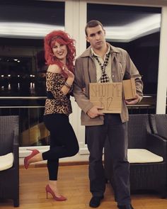 a man standing next to a woman holding a cardboard box