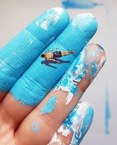 a person with blue paint on their fingers