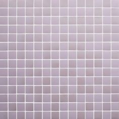 a white tiled wall with small squares on it