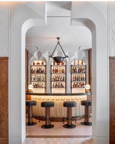 the inside of a bar with several stools