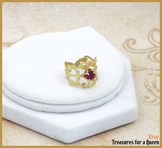 Tudor Ring, Historical Reproduction, Medieval Ring, Tudor Replica, Medieval Jewelry, Renaissance Ring, Medieval Replica, Elizabethan Replica: *This item will be made just for you and may take 3-5 days to ship* Complete your Tudor replica jewelry collection with this simple yet stunning Tudor Era replica ring as seen in various portraits. This adjustable ring is made with a raw brass filigree as the base upon which a 5mm dark red crystal in a quatrefoil setting shines as the focal of this ring. T Tudor Ring, Medieval Ring, Queen Images, Medieval Rings, Tudor Era, Replica Jewelry, Brass Filigree, Medieval Jewelry, Red Crystals