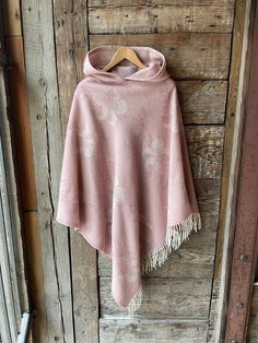 Pink merino wool blanket poncho cape with hood Light pink hooded poncho cape Long wool poncho cape Hooded lambswool blanket poncho floral One size fits fashionably for most everyone, short or tall, big or small. This piece is versatile for both Men's & Women's outdoor fashion, and can be used insider in cooler winter weather to keep warm while reading on the couch. CARE: Hand-wash and hang to dry, light iron if needed, or dry clean. MEASURES: Length at the front of the neckline to the bottom is Pink Shawl Poncho For Winter, Cozy Pink One Size Poncho, Cute Poncho, Womens Outdoor Fashion, Pink Poncho, Cape With Hood, Winter Poncho, Blanket Poncho, Ladies Poncho