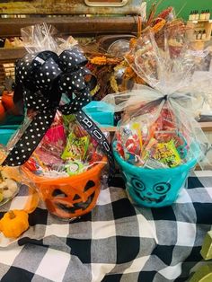 a table topped with baskets filled with candy