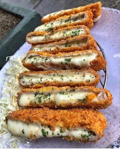 some breaded food is on a plate with gravy and parmesan cheese