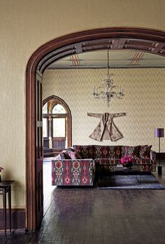 a living room filled with furniture and a chandelier