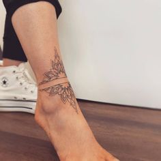 a woman's foot with a tattoo on it