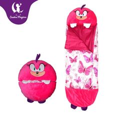 the pink sleeping bag has an angry face on it and is next to a stuffed animal