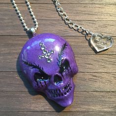 "Purple Evil Hand Painted Resin Skull Pendant from the Sinful Skellies Collection - a range of skull and skeleton themed jewellery and accessories. Add the finishing touch to your gothic outfit - or maybe even your Hallowe'en costume with this sinister grinning skull! Each skull is hand cast and individually painted, then sealed with a gloss resin topcoat. Premium crystals adorn the skull to give it added sparkle! I use UV stable resin and each piece is polished to a high shine and smooth finish Halloween Skull Jewelry With Skull Print, Evil Skull, Inverted Cross, Resin Skull, Gothic Jewellery, Resin Painting, Skull Pendant, Custom Tags, Necklace Unique