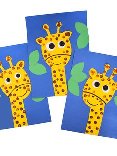 three giraffes made out of construction paper on a blue background with green leaves