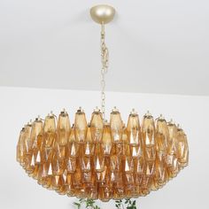 a chandelier hanging from a ceiling in a room with white walls and flooring