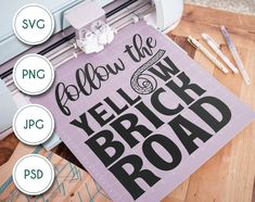 a sign that says follow the yellow brick road next to some cricut markers