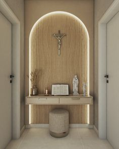 a room with a crucifix on the wall next to a table and stool