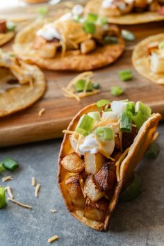 some tacos are sitting on a cutting board