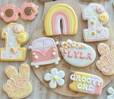 decorated cookies are arranged on a wooden platter