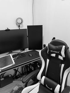 a computer chair sitting in front of two monitors