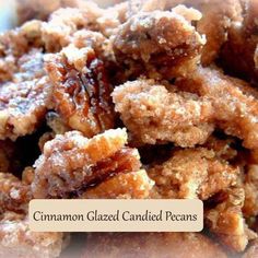 a pile of pecans sitting on top of a white plate with powdered sugar