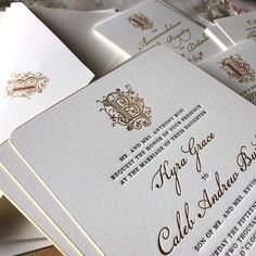 some white and gold wedding cards are stacked on top of each other with the wording