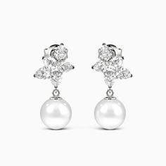 Embrace elegance and charm with these exquisite drop earrings. A dazzling cluster of pear-cut gemstones sits above each radiant pearl, their design blending classic sophistication with a contemporary flair. Effortlessly versatile, this eye-catching combination is the perfect accessory for any occasion requiring understated luxury. Subtle yet striking, the drops will light up your features with their lovely brilliance. *Each piece is handmade, resulting in a potential variance of 0.1-0.2mm during White Pear-shaped Cluster Earrings For Formal Occasions, Elegant Pear-shaped Cluster Earrings For Formal Occasions, Elegant Pear-shaped Cluster Earrings For Anniversary, Elegant White Gold Dangle Cluster Earrings, Elegant White Pear-shaped Cluster Earrings, Elegant Teardrop Cluster Earrings In White Gold, Elegant Cluster Earrings With Prong Setting, Elegant Teardrop Cluster Earrings For Anniversary, Elegant Teardrop Cluster Earrings For Formal Occasions