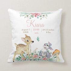 a white pillow with a deer and two animals on it