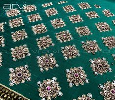 an embroidered table cloth with lots of small jewels on the top and bottom of it