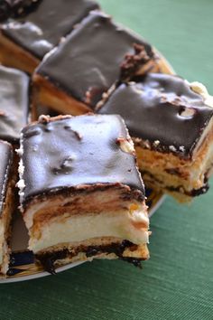 several pieces of cake sitting on top of a white and blue plate next to each other