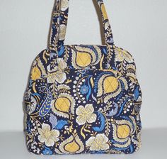 This large Vera Bradley bag measures approx. 12 inches wide by 11 inches in height and the sides measure approx. 4 1/2 inches. The straps have an approx. 10 inch shoulder drop. This bag is in good used condition and is clean and looks fine. The front of the bag has a slip in pocket.  The inside of the bag has 4 slip in pockets and the bag has a double zipper closure. Please feel free to message with any questions. Thank you! Big Handbags, Vera Bradley Bag, Blue Elephant, Blue Elephants, 11 Inches, 10 Inch, Vera Bradley, Bags Handbags, Top Handle Bag