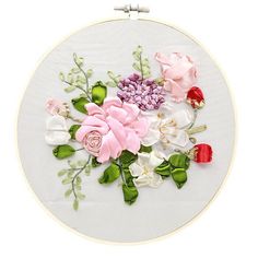 an embroidery kit with pink and white flowers