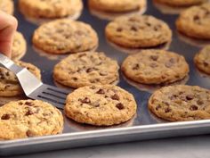 a person is cutting cookies in half with a spatula