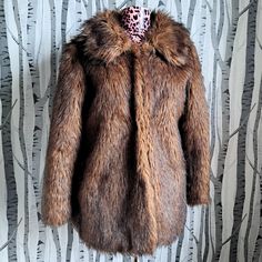 A fabulous guilt free vintage fur! It's completely simulated polyester faux fur made by a brand called Nana. The fake fur is nice and shaggy with light and dark shades of brown to give it a more realistic look.  Made in England in the late 1970s or early 80s, it has a lovely wide shaggy collar, pockets and two hook & eye fastenings at the front. I think it was originally and open coat and the fastenings have been added later.  It's in fantastic condition and will keep you snuggly warm and super Open Coat, Chestnut Brown, Fake Fur, Vintage Fur, Dark Shades, Mink Fur, Size 12, Faux Fur, 1970s