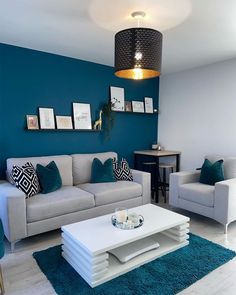 a living room with blue walls and white furniture