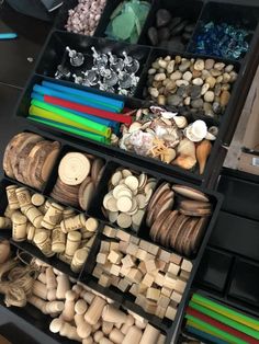 several drawers filled with different types of wood and other items on top of a table