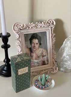 a table with a box, candle and photo on it