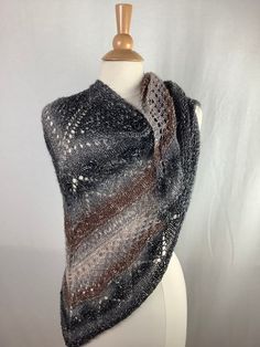 "This beautiful triangular shawl is made from Lion Brand's Shawl in a Ball yarn: 61% cotton, 34% acrylic, 5% metallic fiber. You can wear this lightweight shawl all year long. Color: brown, gray, beige, silver metallic  The metallic thread is much more visible in the reality then in the photos. Measurements are approximate : Length - 66\"168cm                                                             Height - 29\"/74cm   Weight- 5.3oz/ 150g                                                                                                                                   Care instructions: For the best results, hand wash recommended in cold water. Roll in to a towel and squeeze gently excess of water. Lay flat, reshape and dry. Didn't find what you were looking for? To see my other shawls c Shawl In A Ball, Knit Shawl, Metallic Knit, Brown Silver, Knitted Shawls, Metallic Thread, Beige Brown, Shawls And Wraps, Lay Flat