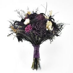 a bridal bouquet with purple and white flowers