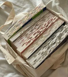 an open book bag sitting on top of a white bed next to a pair of scissors