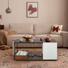 a living room with a couch, coffee table and other items on the floor in front of it