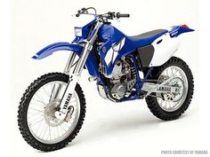 a blue and white yamaha dirt bike on a white background