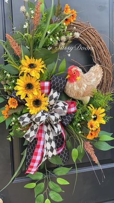 a wreath with sunflowers and a chicken on it is hanging from the front door