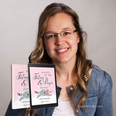 a woman holding up two wedding pamphlets