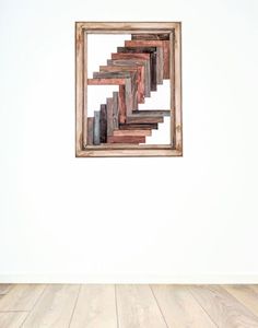 a wooden frame hanging on the wall in an empty room