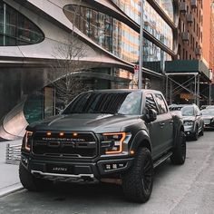 a row of trucks parked on the side of a street