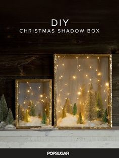 two christmas shadow boxes with lights and trees in them on top of snow covered ground