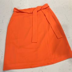 New With Tags Orange Workwear Skirt With Lining, Orange Lined Skirt For Workwear, Midi Skirt Style Skort For Spring Workwear, Orange Workwear Skirt For Spring, Orange Skirt For Workwear In Summer, Spring Workwear Belted Skort, Spring Workwear Knee-length Skort, Chic Orange Knee-length Skirt, Chic Knee-length Orange Skirt