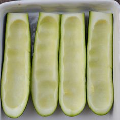 four slices of cucumber in a white dish