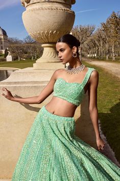 This lehenga set features intricate sequin embroidery in tones of sea green. The ensemble is paired with a one shoulder blouse with an attached net dupatta.From Seema Gujral's Love Notes From Paris Collection DELIVERY TIMEPlease allow 8-12 weeks for your outfit to arrive. FABRIC DETAILSNet Professional cleaning only. Green Sequin Lehenga, Sequin Lehenga, Seema Gujral, Green Lehenga, Padded Blouse, Sequin Embroidery, Pattern Embroidery, Green Sequins, Net Dupatta